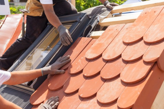 Installation of clay roof tiles in slopping roof